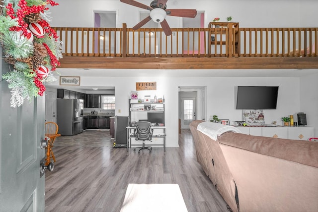 living room featuring ceiling fan, hardwood / wood-style flooring, and a healthy amount of sunlight