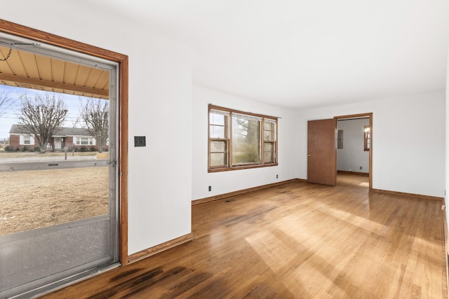 empty room with light hardwood / wood-style flooring