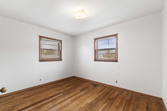 unfurnished room with hardwood / wood-style flooring