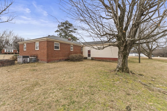 view of home's exterior with a yard and central air condition unit