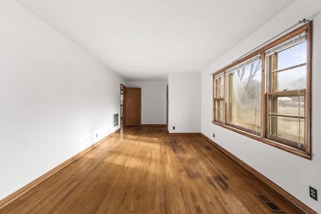 spare room with hardwood / wood-style flooring