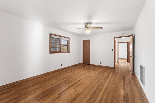 unfurnished room with hardwood / wood-style flooring and ceiling fan