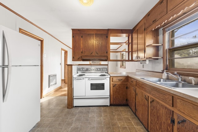 kitchen featuring heating unit, sink, and white appliances