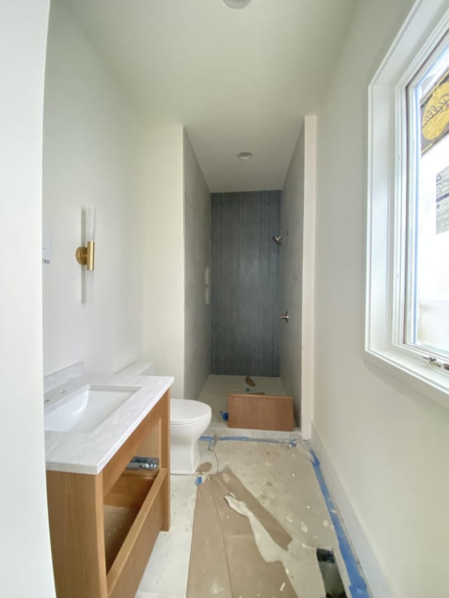 bathroom featuring vanity, toilet, and a shower