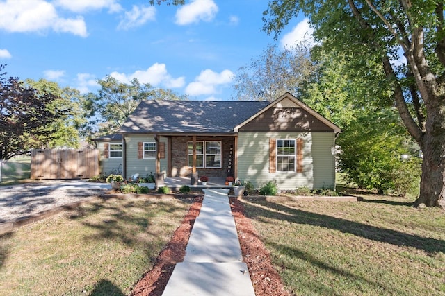 view of front of house with a front yard and covered porch