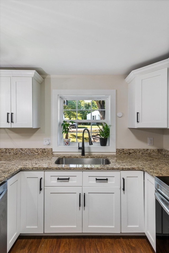 kitchen featuring white cabinetry and sink