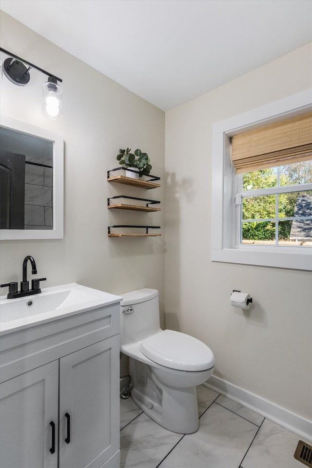 bathroom with vanity and toilet