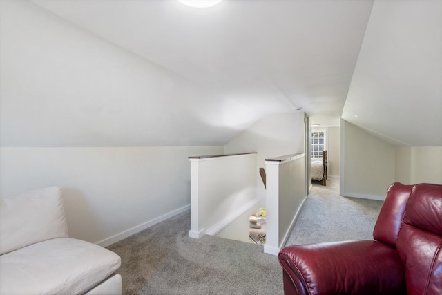 living area featuring vaulted ceiling and light carpet