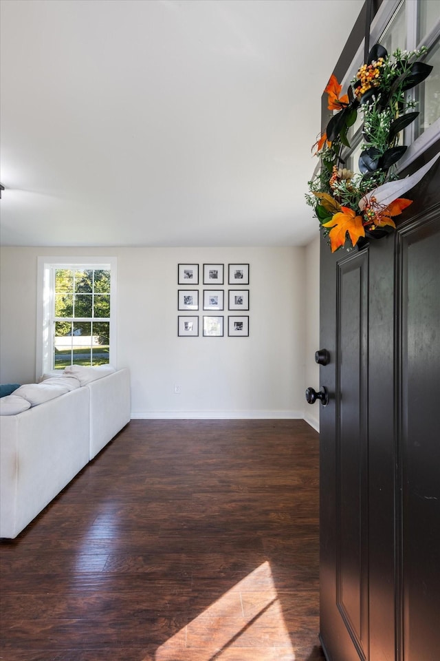 unfurnished living room with dark hardwood / wood-style floors