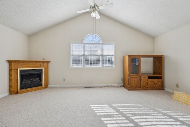 unfurnished living room featuring ceiling fan, lofted ceiling, light carpet, and a textured ceiling