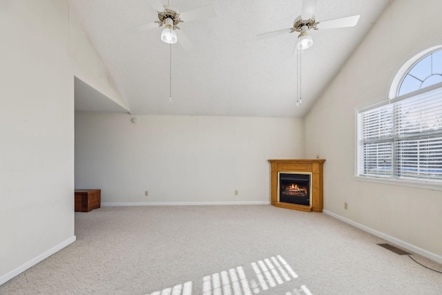 unfurnished living room featuring vaulted ceiling, ceiling fan, and light colored carpet