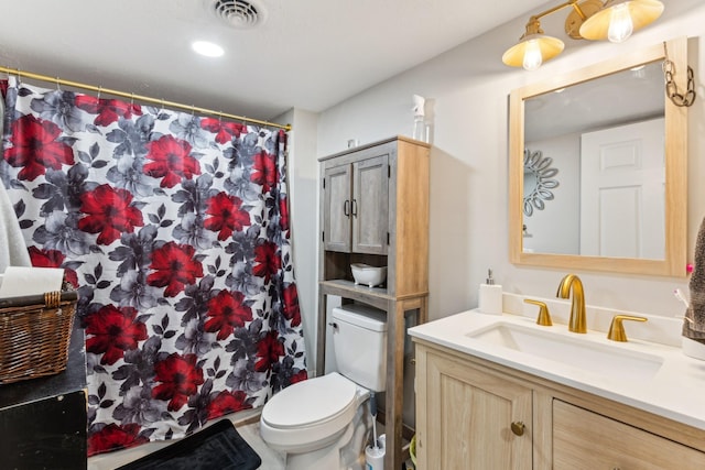 bathroom featuring vanity, toilet, and curtained shower