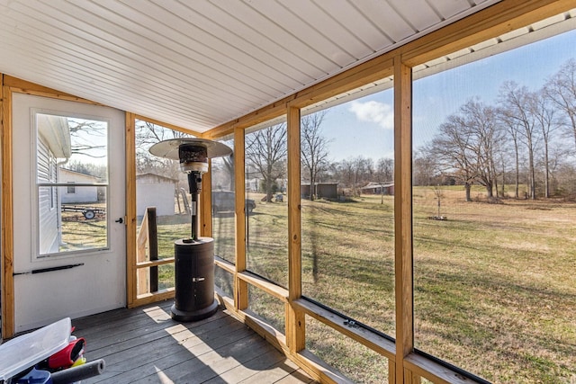 unfurnished sunroom with lofted ceiling