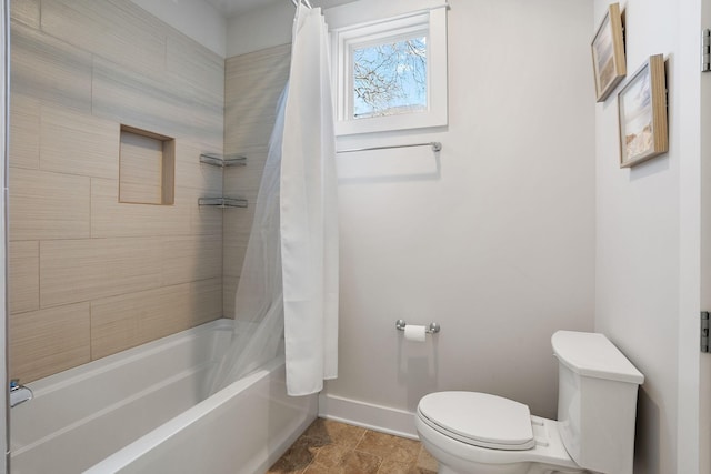 bathroom with shower / bath combo and toilet