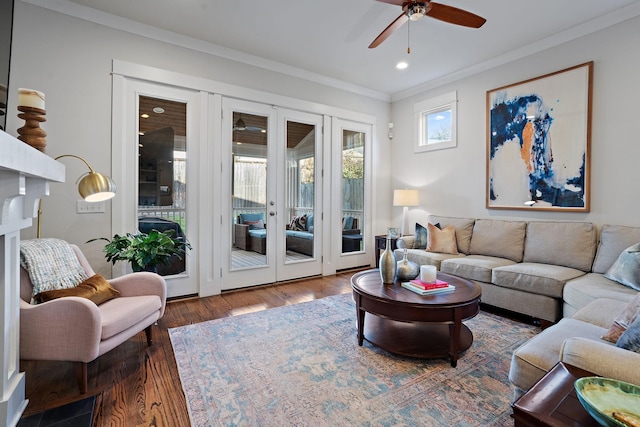 living room featuring crown molding, dark wood-type flooring, and ceiling fan