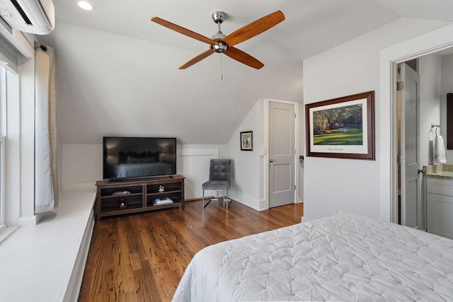 bedroom with vaulted ceiling, connected bathroom, a wall mounted AC, and ceiling fan