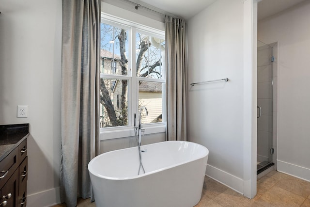 bathroom with tile patterned flooring, shower with separate bathtub, a wealth of natural light, and vanity