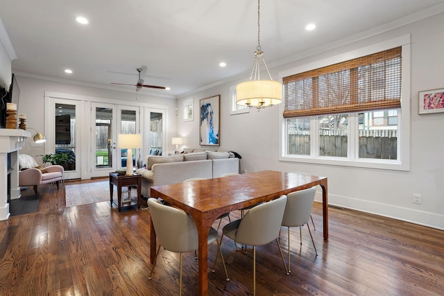 dining space with crown molding, plenty of natural light, and dark hardwood / wood-style floors