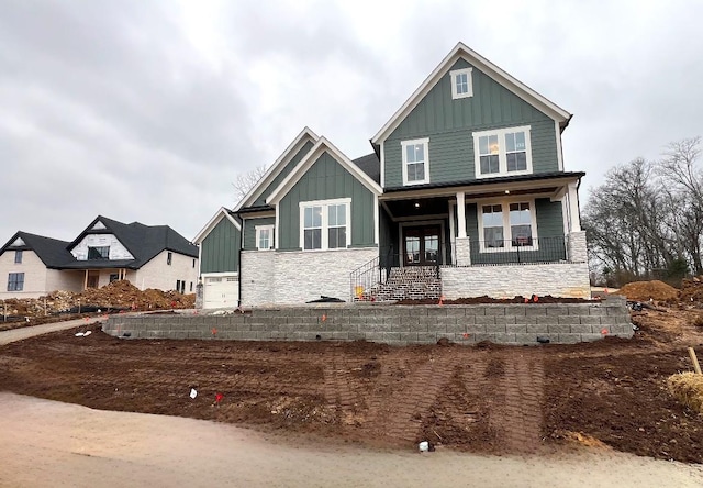 craftsman house featuring a porch and a garage