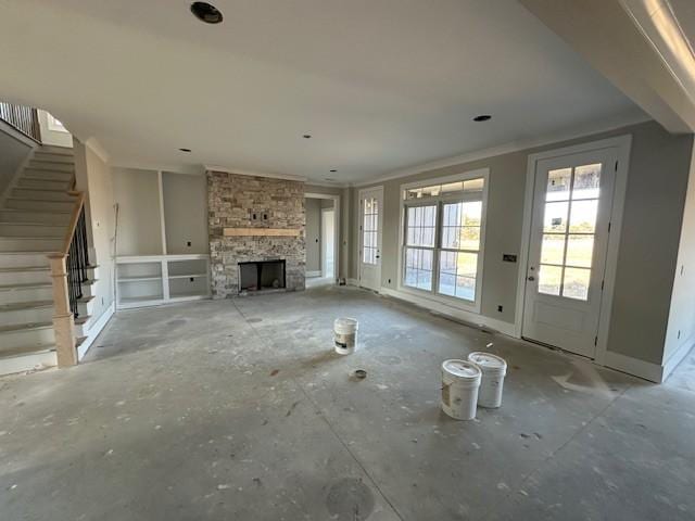 unfurnished living room with a stone fireplace