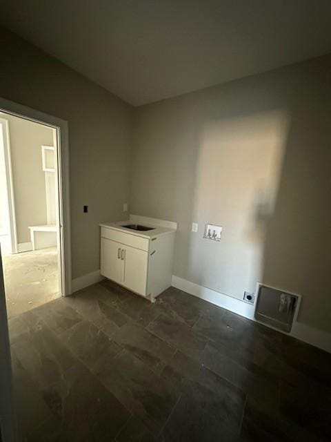 washroom featuring hookup for an electric dryer and sink