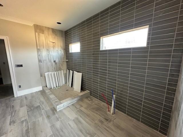 interior space with tile walls and ornamental molding