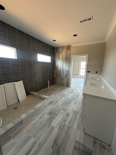 unfurnished room featuring tile walls and a wealth of natural light