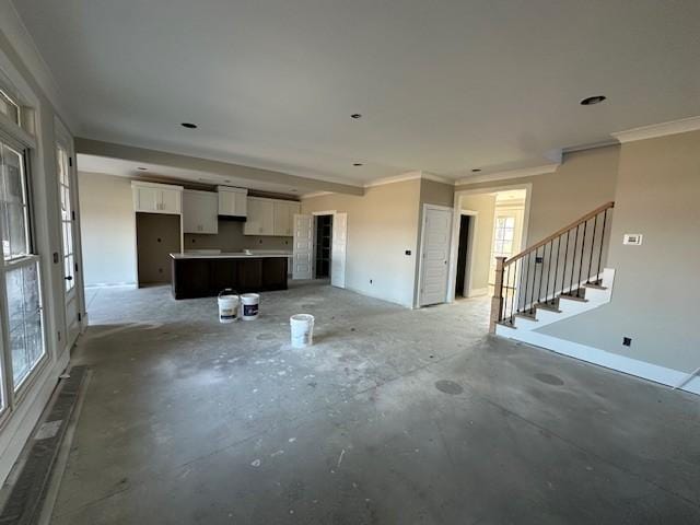 unfurnished living room with ornamental molding