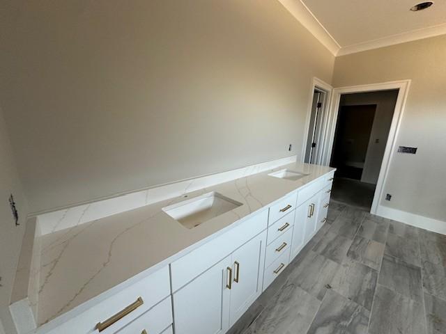 bathroom with vanity and crown molding