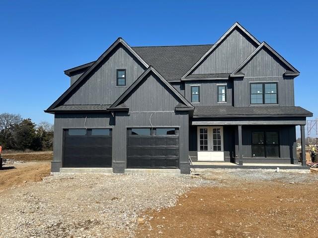 view of front of house with covered porch and a garage