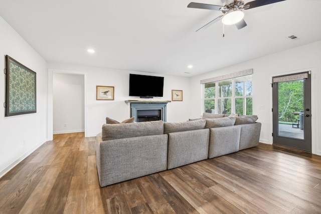 living room featuring hardwood / wood-style floors and ceiling fan