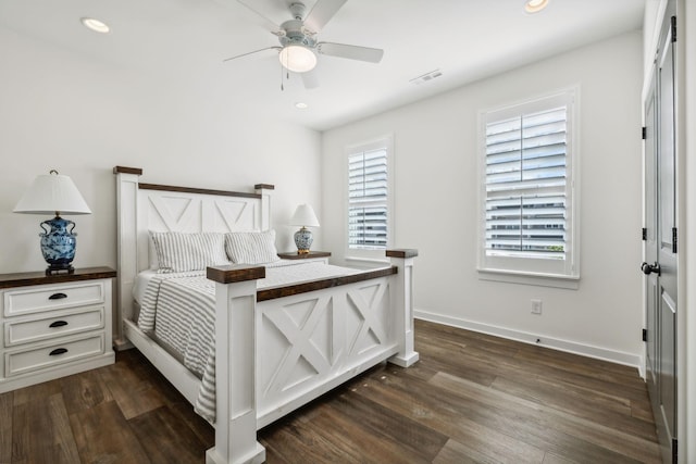 bedroom with dark hardwood / wood-style flooring and ceiling fan