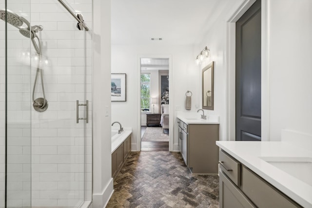 bathroom with shower with separate bathtub and vanity