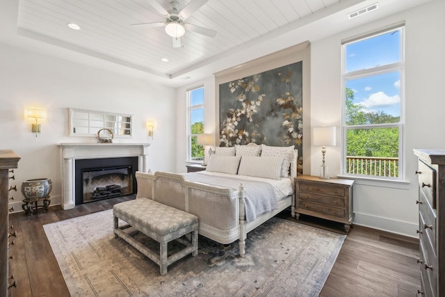 bedroom featuring a raised ceiling, wooden ceiling, dark hardwood / wood-style floors, and ceiling fan