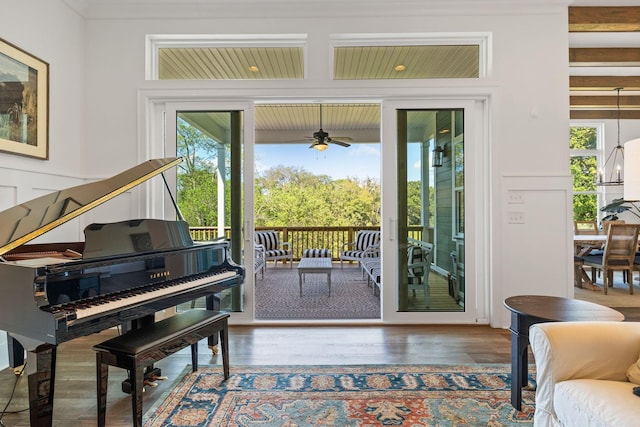 doorway with hardwood / wood-style flooring and ceiling fan with notable chandelier