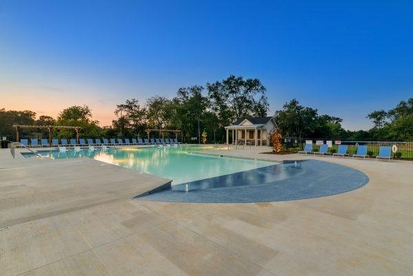 pool at dusk featuring a patio area