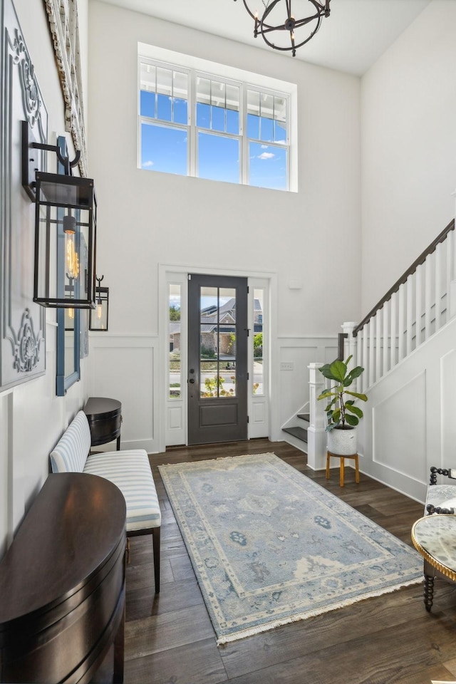 entryway with a towering ceiling and dark hardwood / wood-style floors