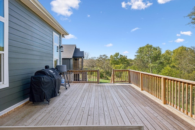 wooden deck with a grill