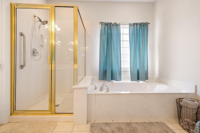 bathroom featuring tile patterned flooring and separate shower and tub