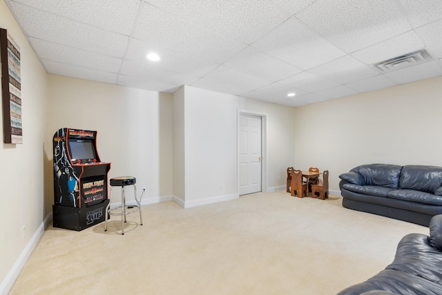 living room with a paneled ceiling and carpet