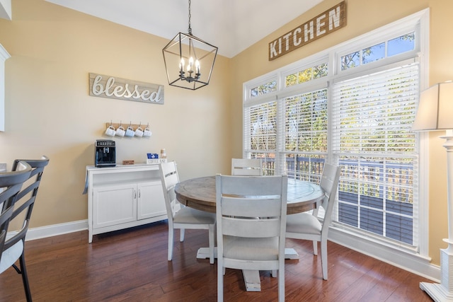 dining space with a notable chandelier and dark hardwood / wood-style flooring