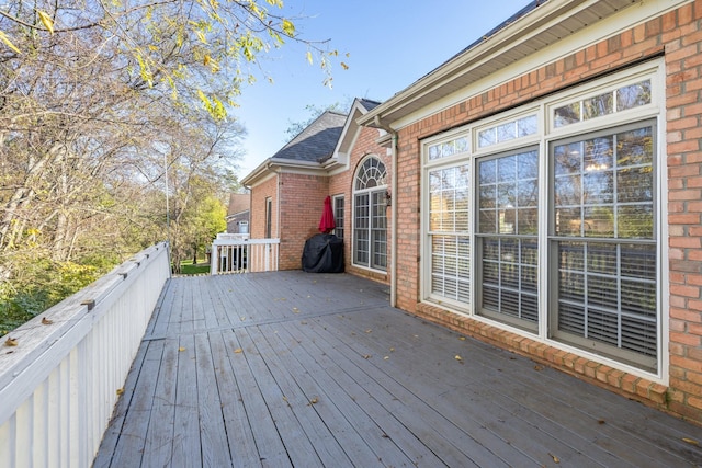 wooden terrace featuring a grill