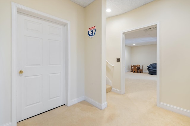 hall with light colored carpet