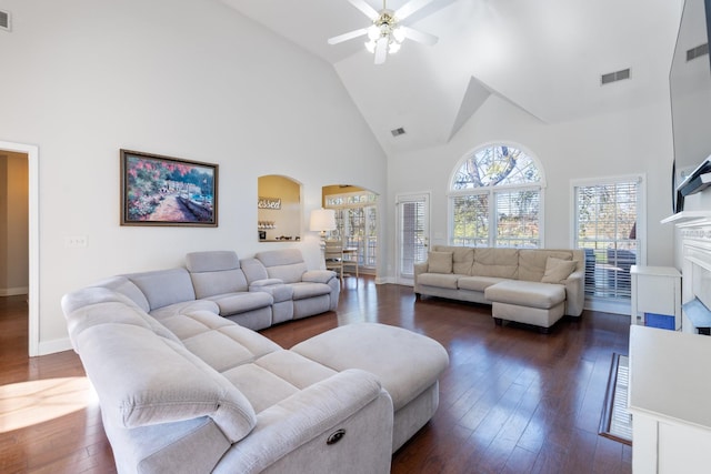 living room featuring high vaulted ceiling, dark hardwood / wood-style floors, and ceiling fan