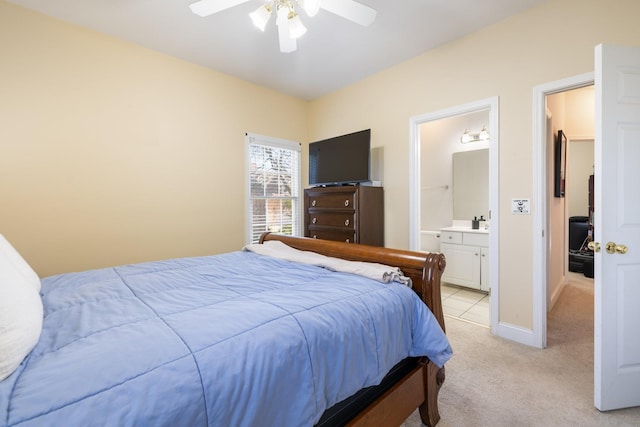 carpeted bedroom featuring ceiling fan and ensuite bathroom