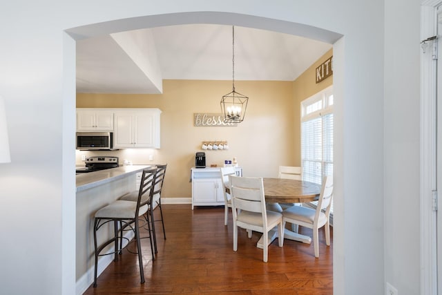 dining space featuring a chandelier and dark hardwood / wood-style flooring