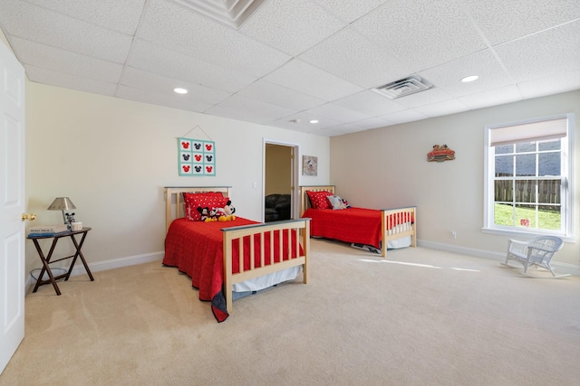 bedroom with a paneled ceiling and carpet flooring