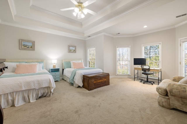 bedroom with crown molding, a tray ceiling, ceiling fan, and carpet