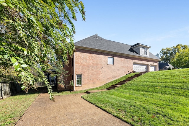 view of side of property with a yard