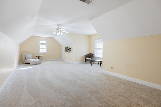 additional living space with light carpet, lofted ceiling, and ceiling fan